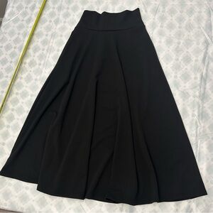 The modest skirt falls below the knee has pockets on the sides and is hghwaistd.